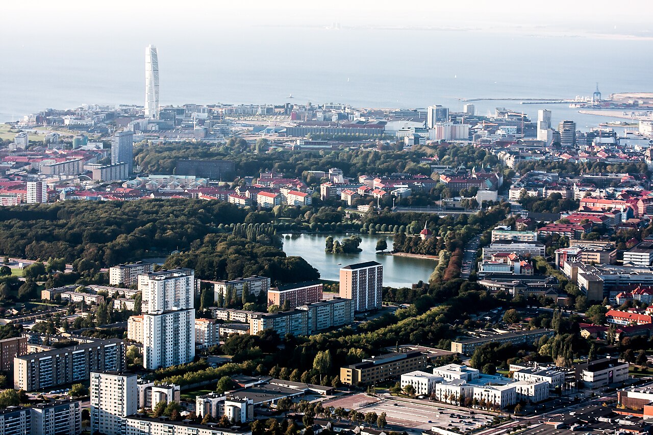 Malmö, Sweden — aerial view of the city that became the living argument for every claim the Swedish establishment refused to debate. By 2023, Malmö's population was over 45% foreign-born, its Rosengård district had been classified by Swedish police as a 